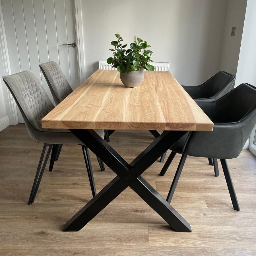 Ash dining table on black Chunky X-Frame box section legs in a bright dining room